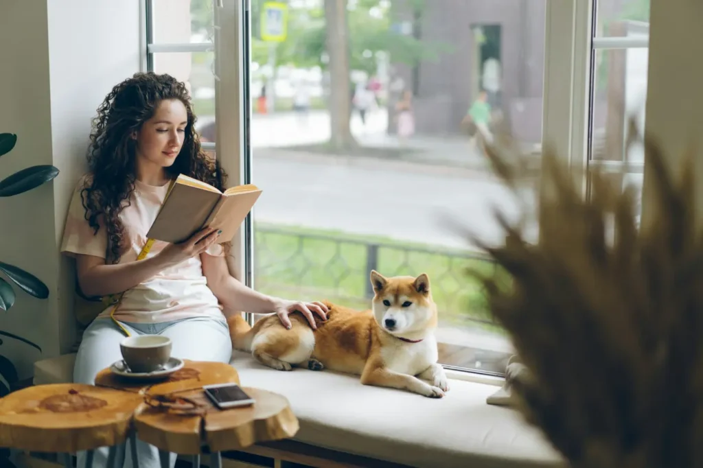 Woman reading book, enjoying 4-day work week results 2026